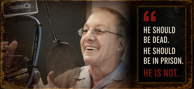 Vince Ciacci smiling while recording the MOBSHOT podcast in a recording studio. The image includes the quote, He should be dead. He should be in prison. He is not.